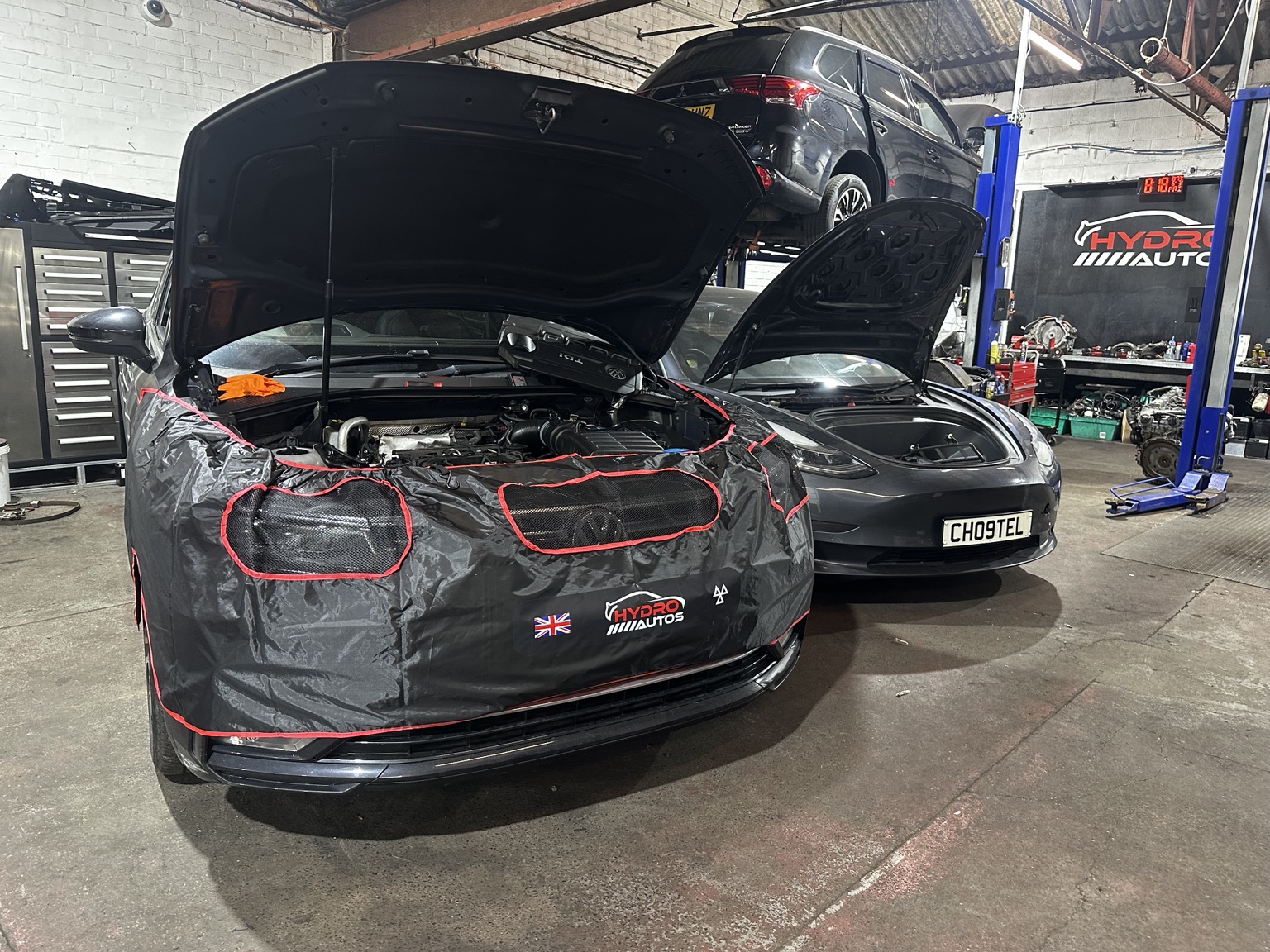 Tesla vehicles being serviced inside the Hydro Autos workshop